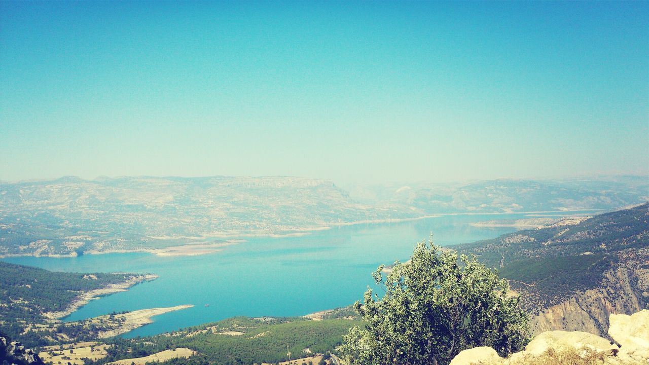 clear sky, tranquil scene, copy space, mountain, scenics, tranquility, blue, beauty in nature, landscape, nature, high angle view, tree, mountain range, idyllic, day, non-urban scene, water, outdoors, no people, lake