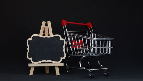 Empty chairs against black background