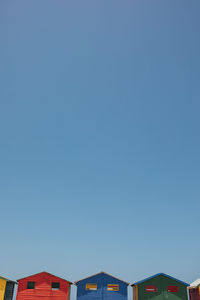 Low angle view of buildings against clear blue sky