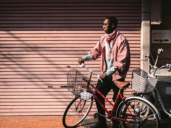 YOUNG MAN RIDING BICYCLE ON STREET