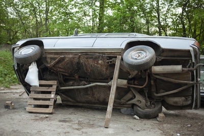 Abandoned vintage car on field