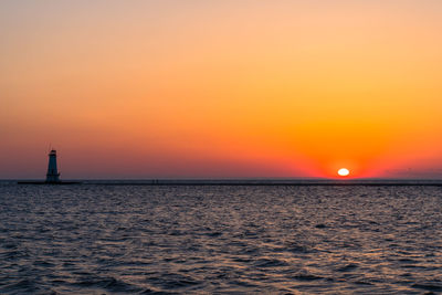 Scenic view of sea against orange sky