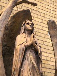 Low angle view of statue against wall