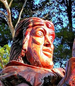 Low angle view of statue against trees