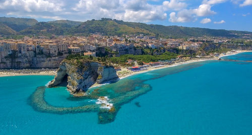 Aerial view of sea and mountains against sky