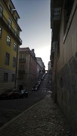 Street amidst buildings against sky in city