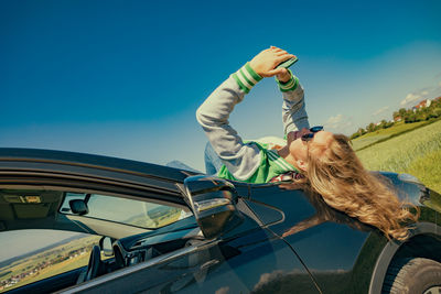 Low angle view of man with arms raised