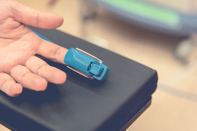 Cropped image of hand with pulse oximeter