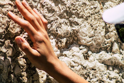 Human hand on rock