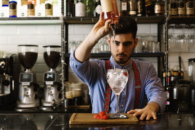 Bartender preparing drink in bar