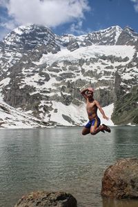 Full length of man on rocks against mountain