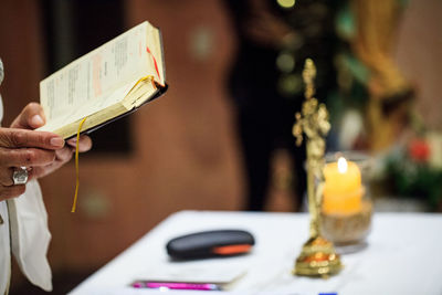 Cropped hands of person holding bible at church