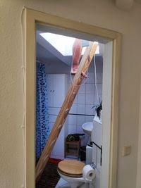 Man climbing a ladder in his bathroom