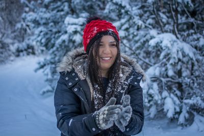 Woman standing on snow covered field