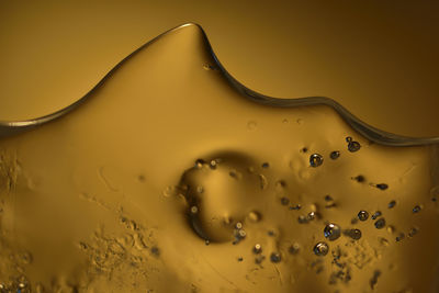 Close-up of water against yellow background