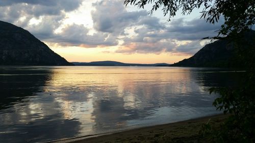 Scenic view of lake against cloudy sky