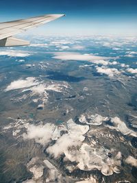 Aerial view of aircraft wing against sky