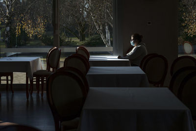 Woman sitting on chair in restaurant