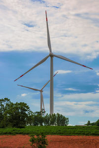 Windmill on field against sky