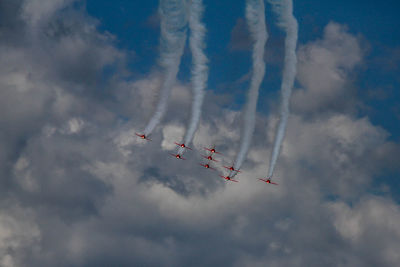 Low angle view of airshow against sky