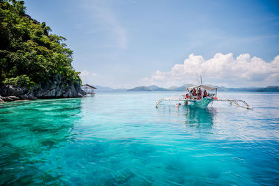 Tourist enjoying the clear turquise waters of coron, palawan, philippines.