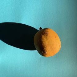 Close-up of apple on table against blue background