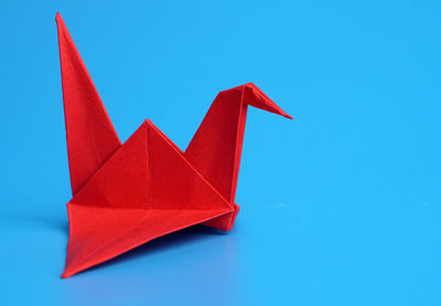 High angle view of paper flag against blue background