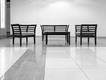 Empty chairs on floor against wall in hotel lobby