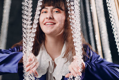 Portrait of young woman sitting on hammock