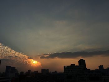 Silhouette buildings against sky during sunset