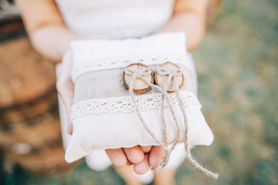 Midsection of woman holding gift outdoors