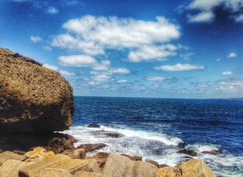 Scenic view of sea against cloudy sky