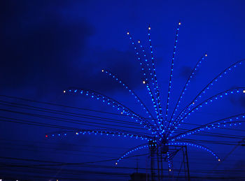 Low angle view of illuminated ferris wheel at night