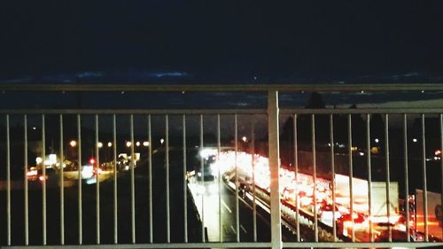 Illuminated railing in city at night