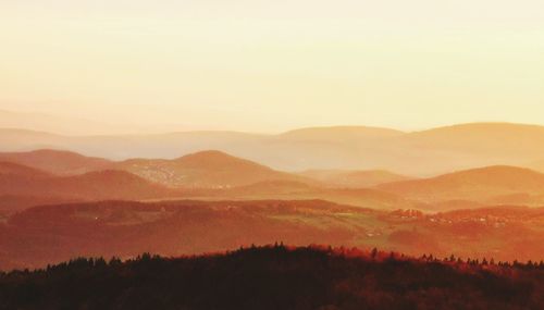 Scenic view of silhouette mountains against sky during sunset