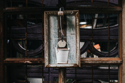 Old rusty bucket hanging outdoors