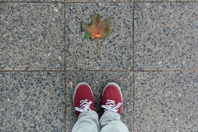 Low section of person standing on tiled floor