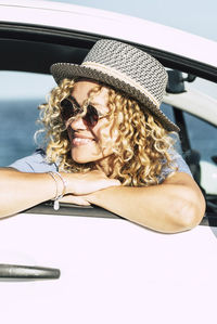 Low angle view of young woman in car