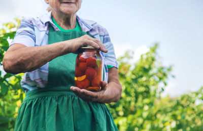 Portrait of woman holding fruits