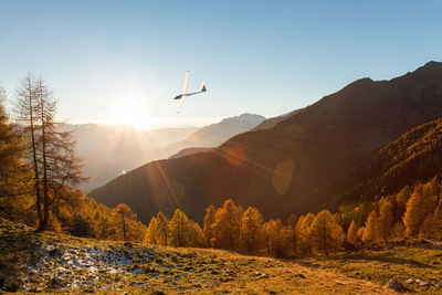 Scenic view of mountains against bright sun