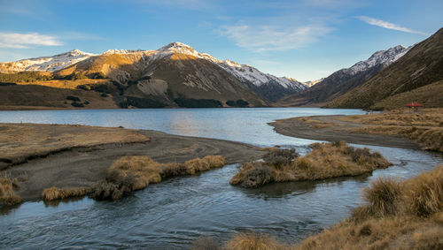 Scenic view of lake and mountains against sky