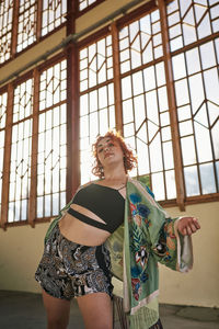 Young alternative redhead girl dancing in a green kimono