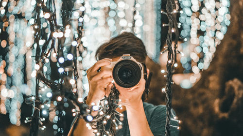 Portrait of woman photographing outdoors