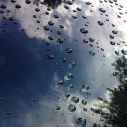 Close-up of bubbles against sky during rainy season