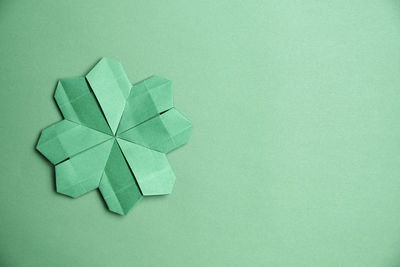 High angle view of green paper against blue background