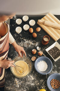 High angle view of woman preparing food on table at home