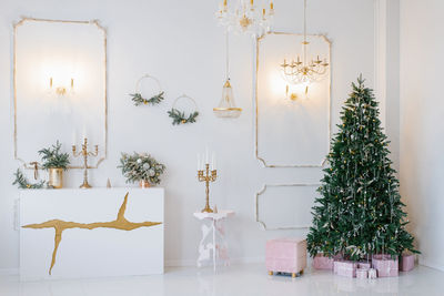 Elegant classic interior of the living room, decorated for christmas and new year in bright colors