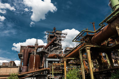Low angle view of industry against sky