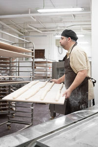 Side view of man working in workshop