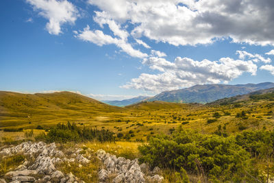 Scenic view of mountains against cloudy sky